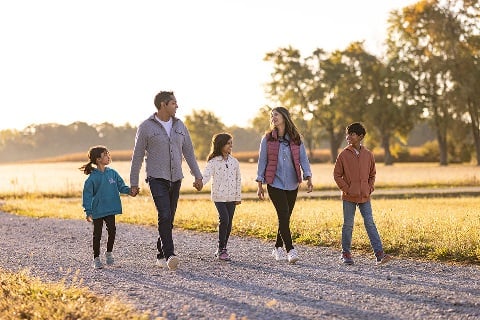 Family walking down a gravel path