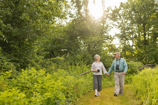 Larry and Elaine walks their land