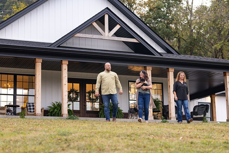 Veirs Family walks through the front yard with their Rural 1st loan officer