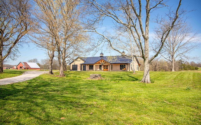 View of the front of a barndominium from a distance.