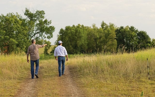 Two men walking in a field